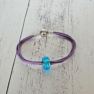 Pandora purple bracelet with blue glass bead.